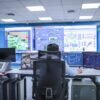 Operator in a modern control room managing technological systems in El Agustino, Lima.